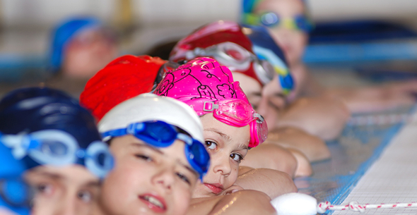 Faces of children in swimming pool
