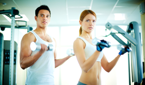 Couple with weights in the gym