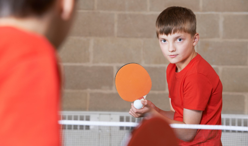 Junior table tennis player about to serve