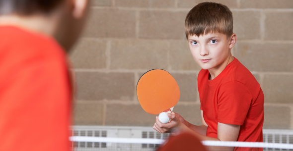 Junior table tennis player about to serve